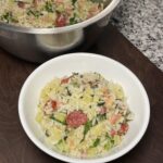 A bowl of rice with Chinese sausage, ham, and bok choy