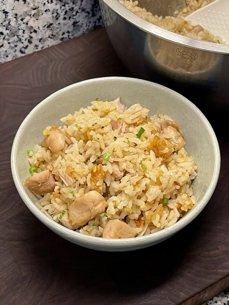 Bowl of rice with chicken, minced ginger, and scallion