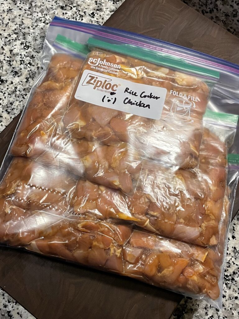 Large food storage bag with smaller bags of marinated chicken thigh pieces